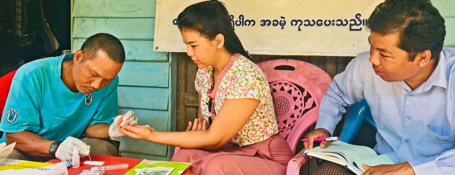 U Myo San, MHAA-trained integrated community malaria volunteer, performs a malaria rapid diagnostic test for Thidar Aung, Malaria Programme Associate, UNOPS-PR, during a field monitoring visit to, Samee 2-Quarter village, Paletwa, Chin State. RDT allows the diagnosis of malaria in 15 minutes, significantly cutting the time between blood sample and diagnosis. Photo: UNOPS
