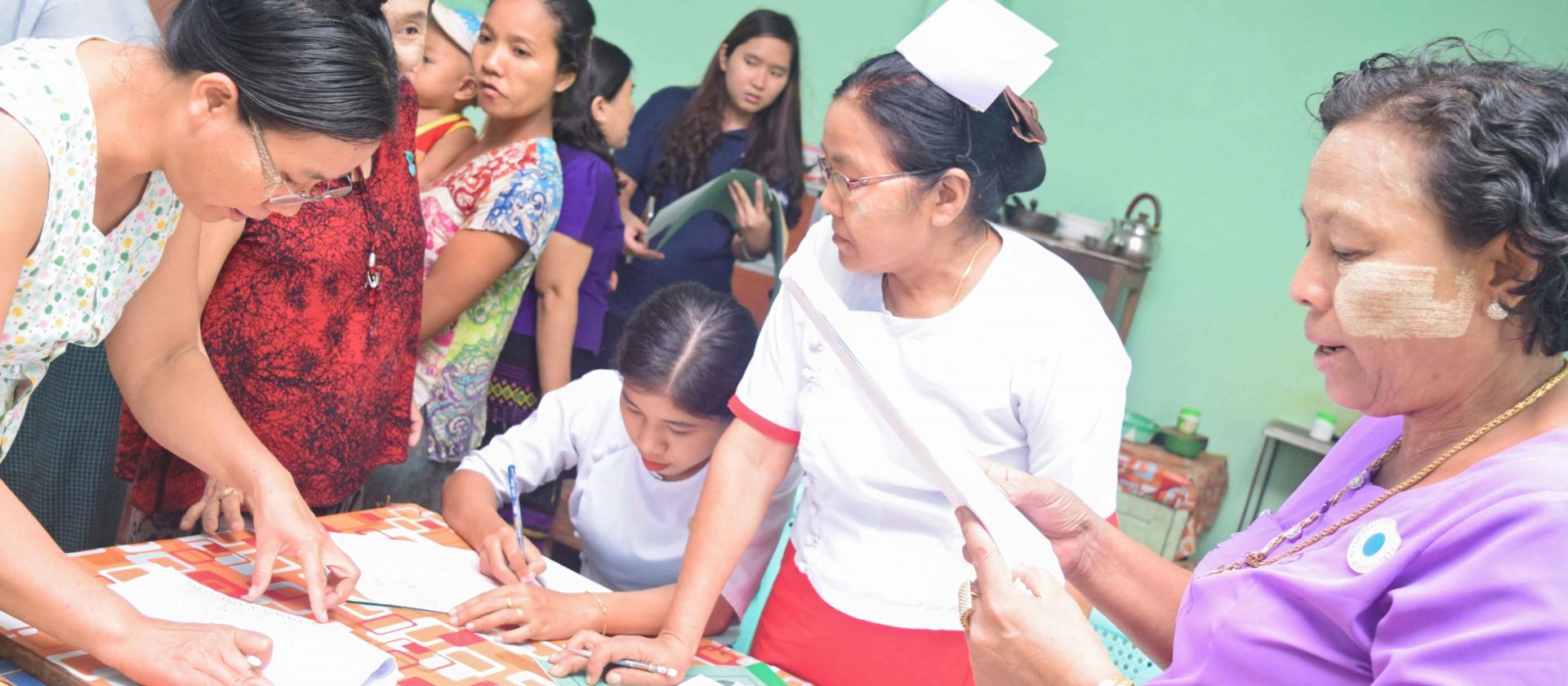 Daw Naw May, a midwife in Madauk Rural Health Centre, attends to registration for LLIN distribution. Photo: UNOPS Daw Naw May, a midwife in Madauk Rural Health Centre, attends to registration for LLIN distribution. Photo: UNOPS