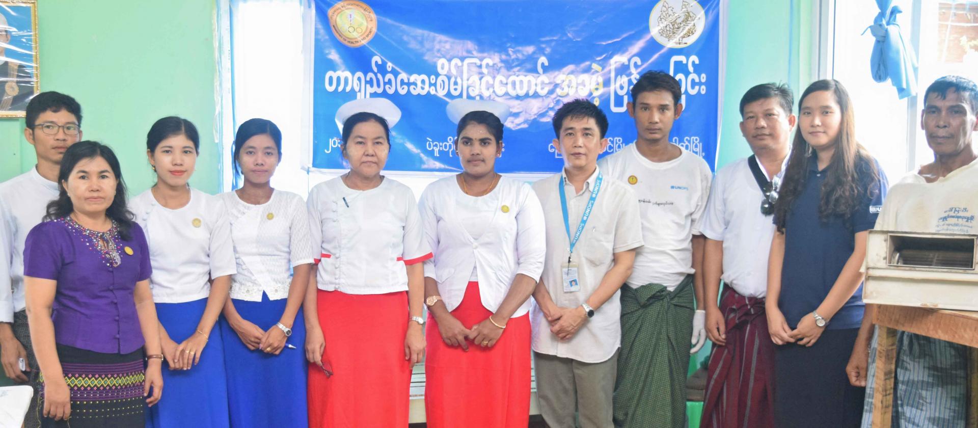 UNOPS-PR logistics team together with Nyaung Lay Pin Hospital Medical Superintendent Dr Thaung Dan Oo, Bago Region VBDC Lab Technician Grade I Daw Hla Hla Htay and Madauk Village Rural Health Centre team. Photo: UNOPS UNOPS-PR logistics team together with Nyaung Lay Pin Hospital Medical Superintendent Dr Thaung Dan Oo, Bago Region VBDC Lab Technician Grade I Daw Hla Hla Htay and Madauk Village Rural Health Centre team. Photo: UNOPS