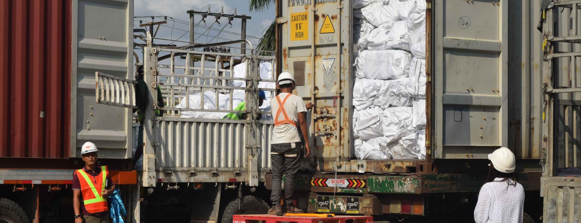 UNOPS-PR Logistics team inspect seal number as the LLINs container is opened for inspection. Photo: UNOPS