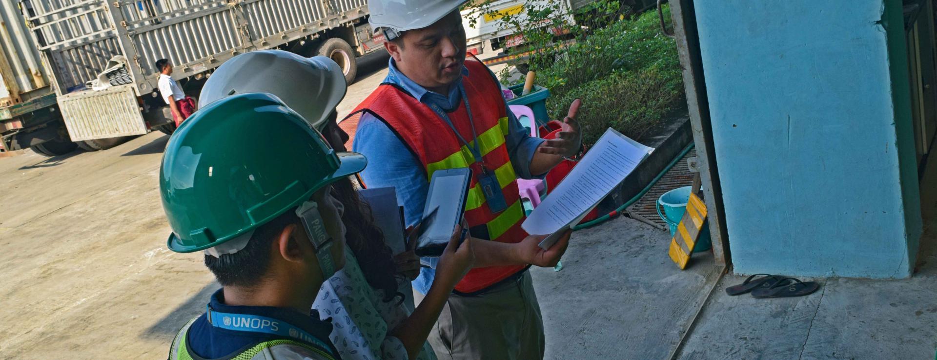 UNOPS-PR Logistics Officer Ko Sai Ohm Kham explains the details of the waybill sent with the distributer to partners implementing the RAI2E programme. Photo: UNOPS