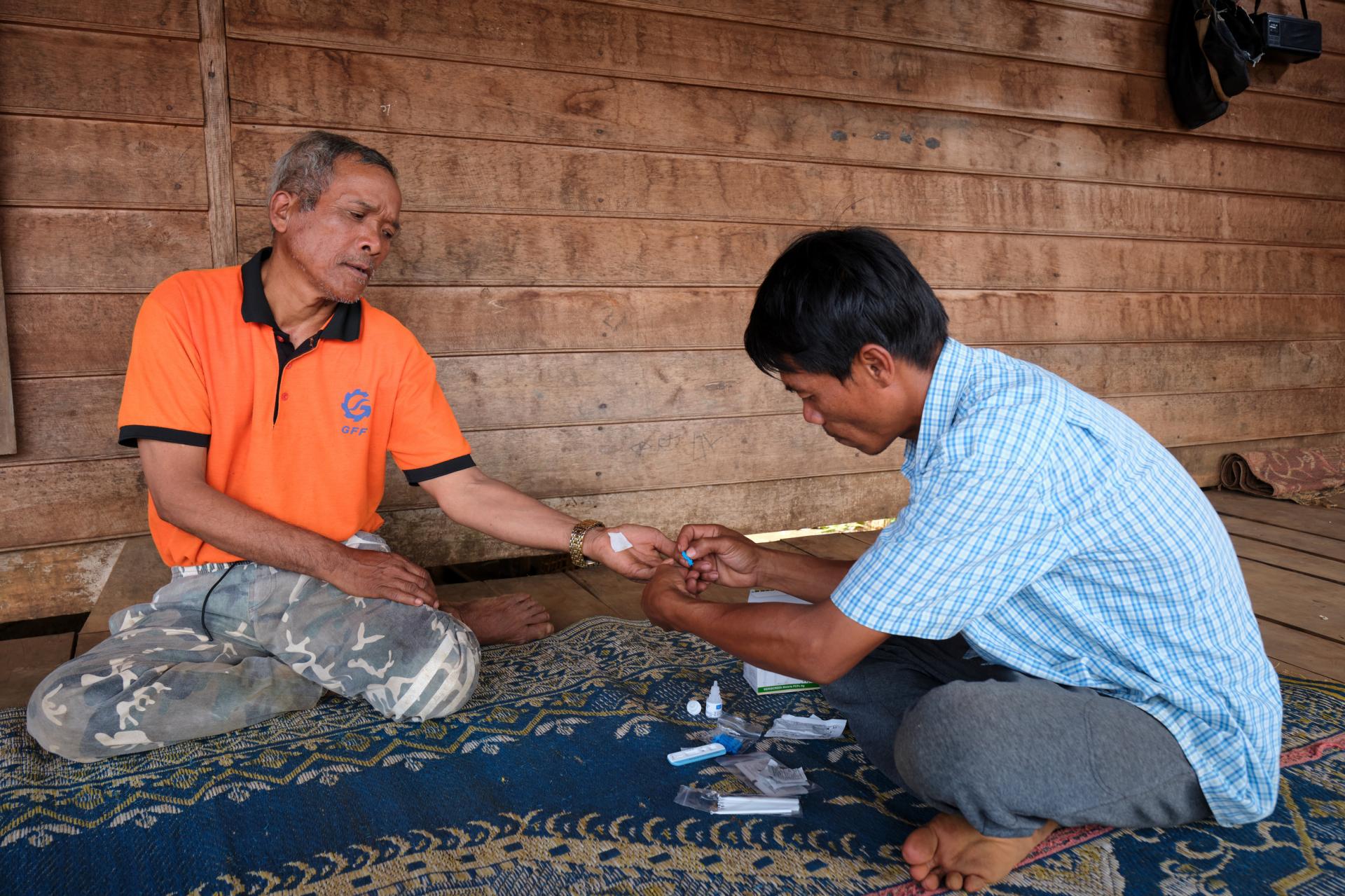 Village malaria worker Sisomphang testing a villager for malaria during a home visit. Photo: BART VERWEIJ Village malaria worker Sisomphang testing a villager for malaria during a home visit. Photo: BART VERWEIJ