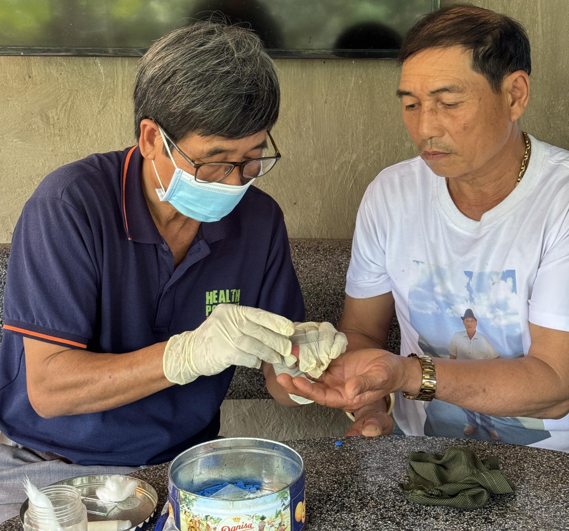 A Mobile Outreach Team (MOT) member conducts a malaria test for Nguyen Van Phuc during a routine follow-up visit to ensure his continued health and prevention. Photo: HPA 